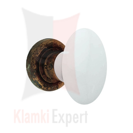 Klamka FLAVIA 685, porcelana biała, rozeta 103 AN patynowany antyczny